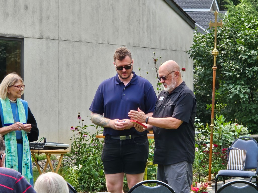 Deacon gifting a church member a painting.