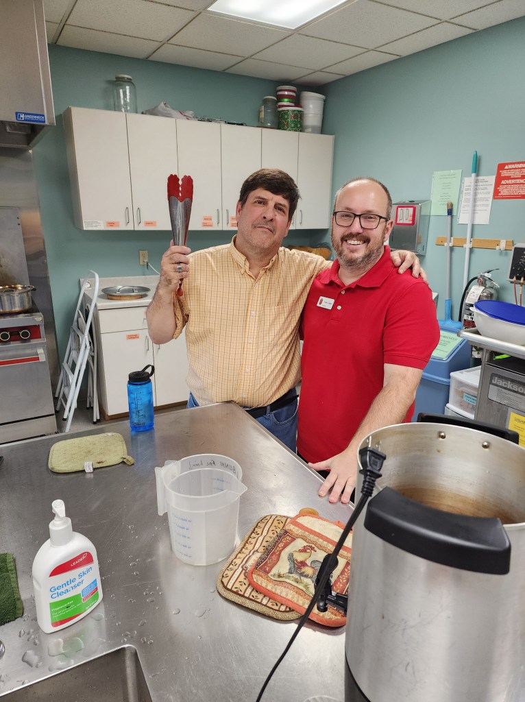 Two volunteers preparing food. 